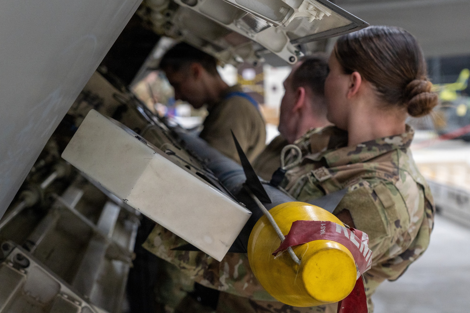 U.S. Air Force Airmen assigned to the 525th Force Generation Squadron load an AIM-9M onto an F-22 Raptor during the annual Mission Generation Competition at Joint Base Elmendorf-Richardson, Alaska, Jan. 9, 2026.