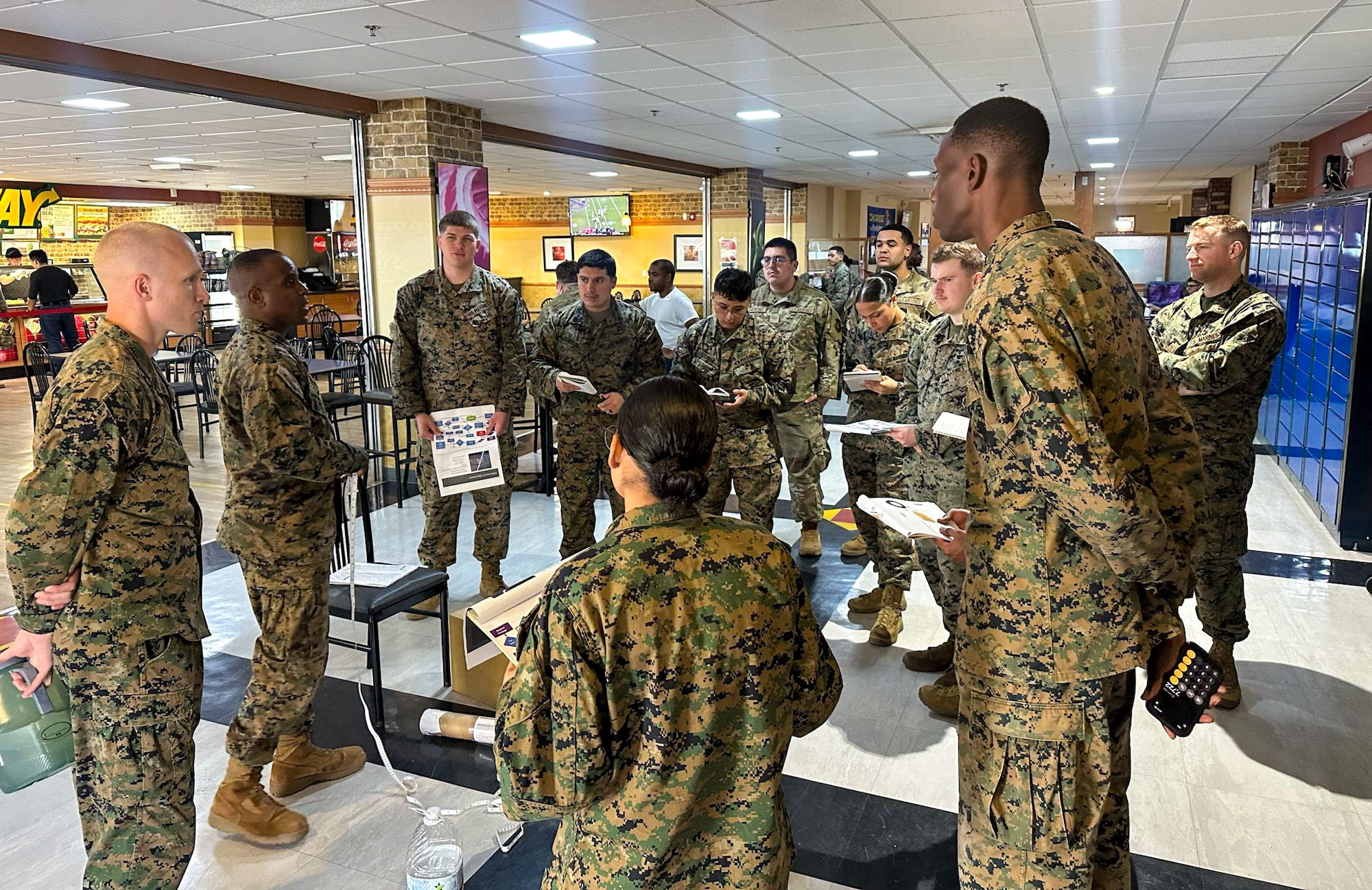 A group of U.S. service members participate in a brief.