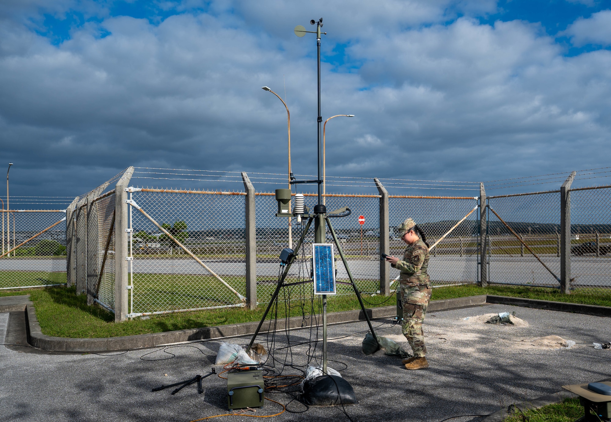 U.S. Air Force Airman 1st Class Faith Chavez, 18th Operations Support Squadron weather forecaster, checks readings on a standard weather sensor tower on Kadena Air Base, Japan, Jan. 12, 2026. In emergency situations, the 18th OSS weather flight is trained to provide quick and accurate personalized weather forecasts for pilots to safely get off the ground on short notice. (U.S. Air Force photo by Senior Airman Jamal Berry II)