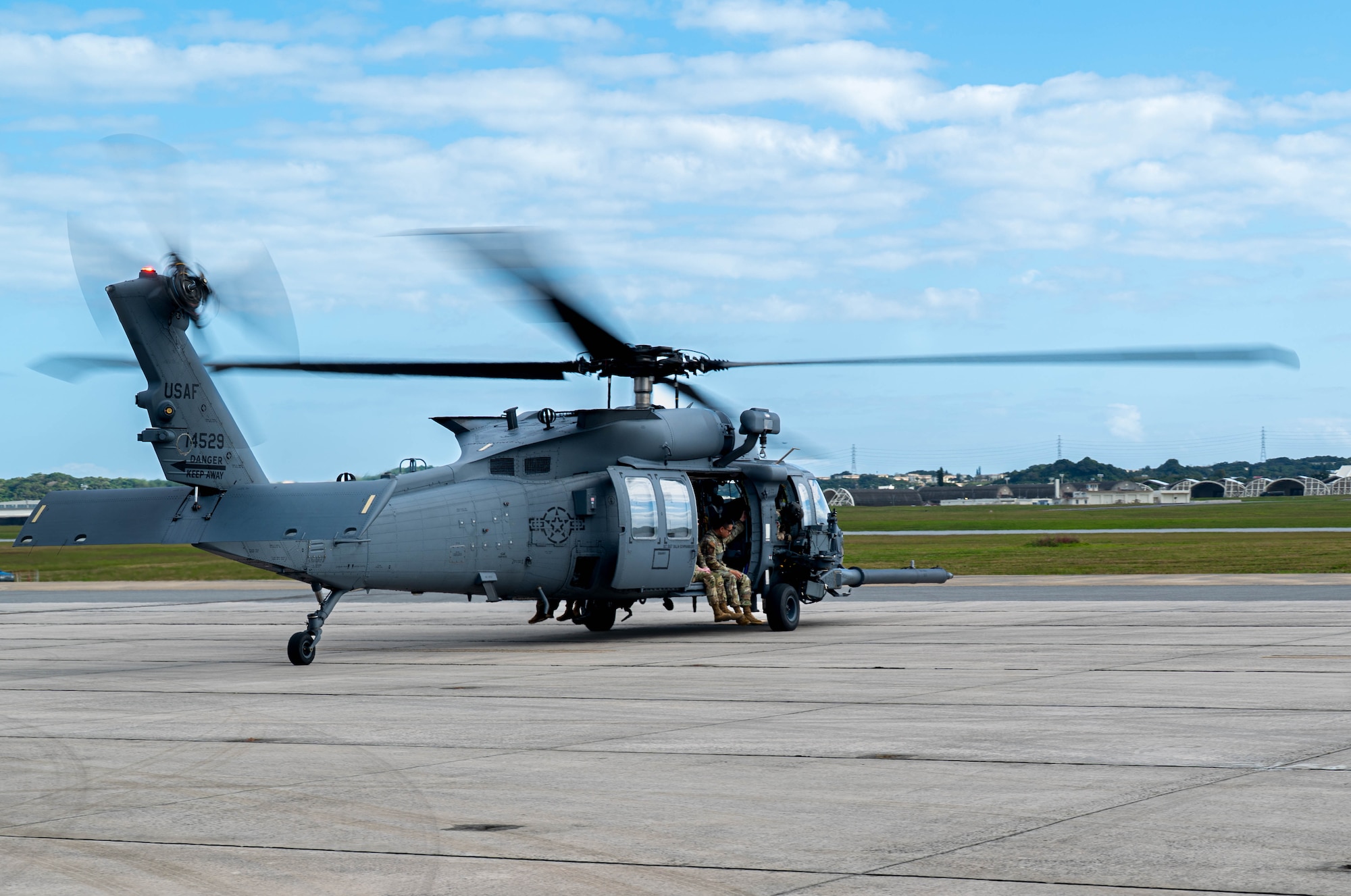 U.S. Air Force Airmen assigned to the 18th Operations Support Squadron weather flight prepare for departure in an HH-60W Jolly Green II to Whiskey-174 from Kadena Air Base, Japan, Jan. 12, 2026. The flight established a new sensor tower to enhance forecasting accuracy and readiness across the Indo-Pacific. (U.S. Air Force photo by Senior Airman Jamal Berry II)