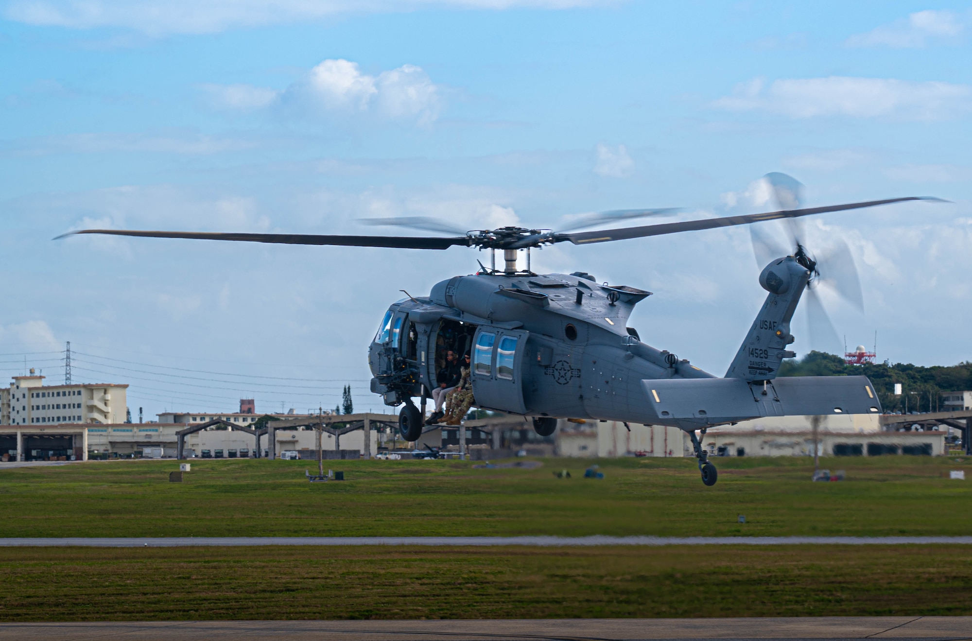 U.S. Air Force Airmen from the 18th Operations Support Squadron Weather Flight depart Kadena Air Base, Japan, aboard an HH-60W Jolly Green II, Jan. 12, 2026. The 18th OSS Weather Flight provides real-time environmental intelligence that enables joint and allied forces to operate safely and effectively throughout the region. (U.S. Air Force photo by Senior Airman Jamal Berry II)