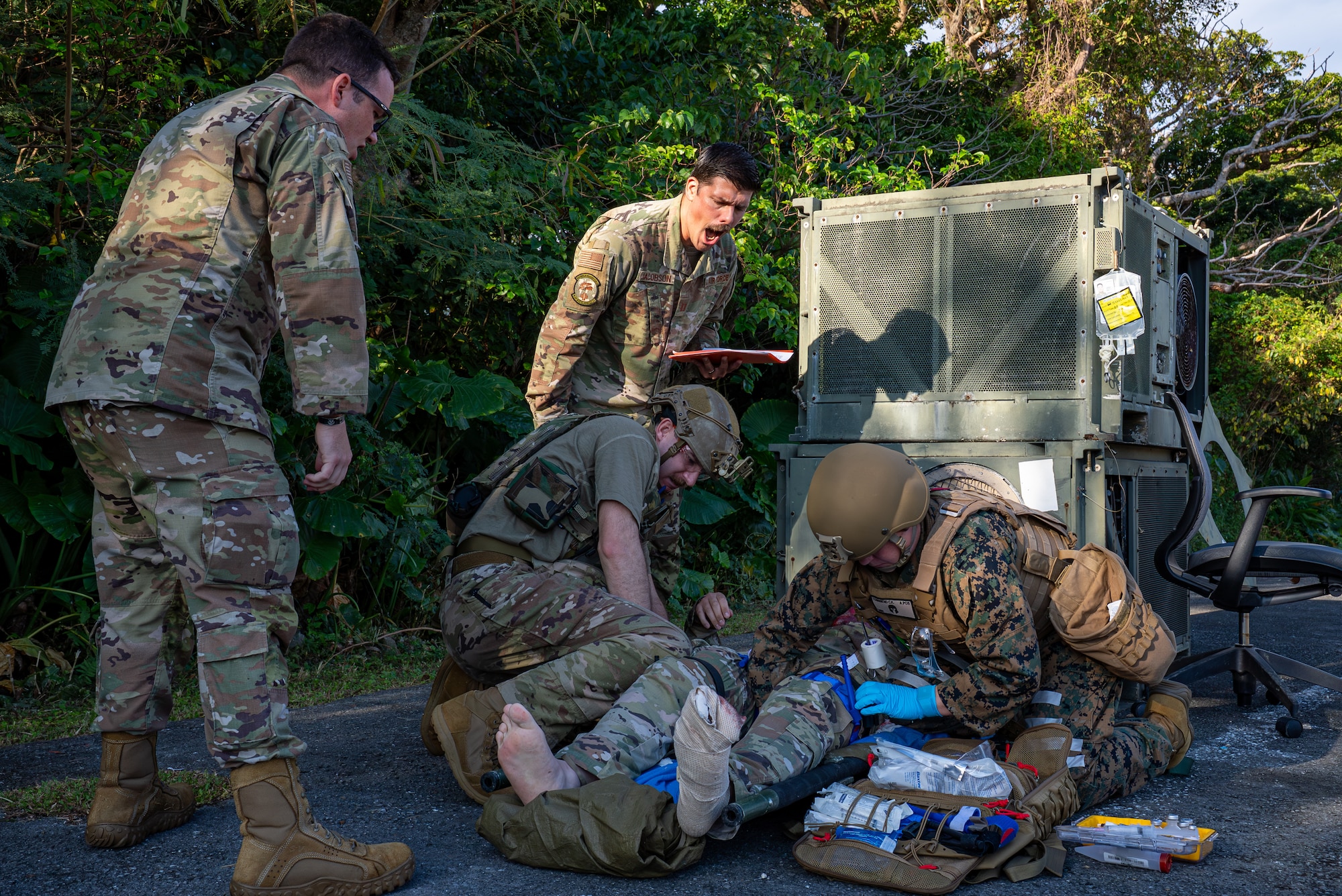 Instructors simulate adverse conditions during a medical evaluation course.