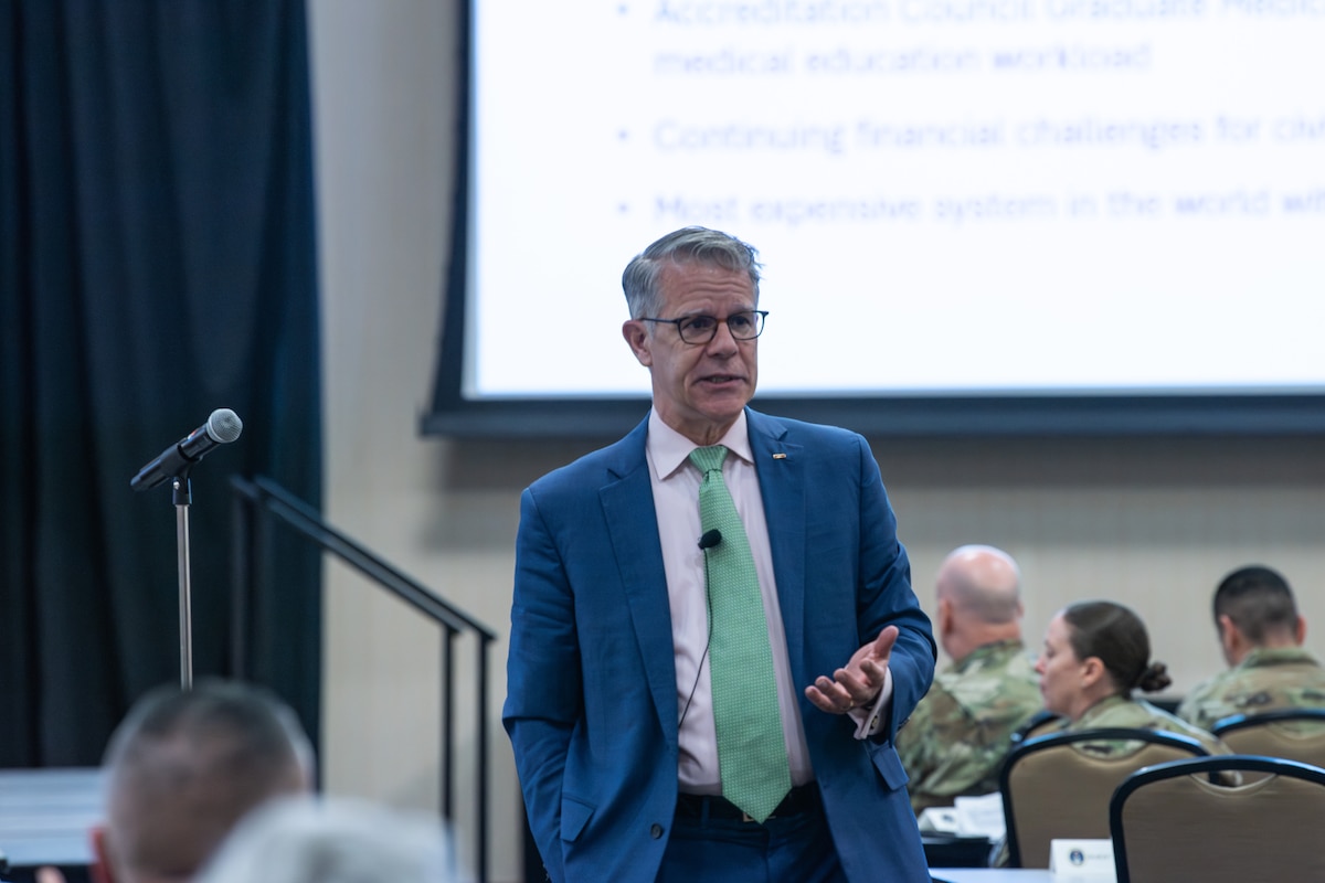 Image of a civilian talking to a group of people.