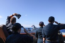 U.S. Navy Sailors aboard Arleigh Burke-class guided-missile destroyer USS John Finn (DDG 113) wave at the Philippine Navy Jose Rizal-class frigate BRP Antonio Luna (FF151) during the Maritime Cooperative Activity (MCA) in the Philippines’ Exclusive Economic Zone, Jan. 26, 2026.