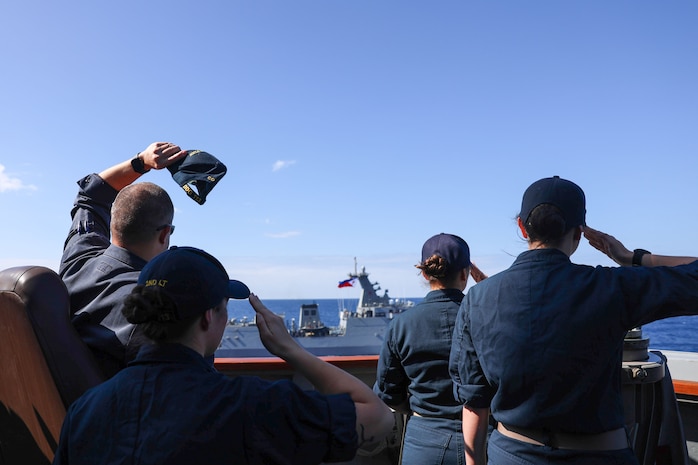 U.S. Navy Sailors aboard Arleigh Burke-class guided-missile destroyer USS John Finn (DDG 113) wave at the Philippine Navy Jose Rizal-class frigate BRP Antonio Luna (FF151) during the Maritime Cooperative Activity (MCA) in the Philippines’ Exclusive Economic Zone, Jan. 26, 2026.