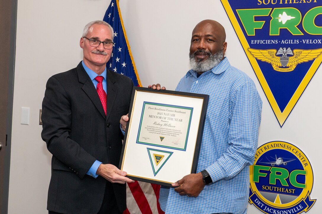 260121-N-DG679-1001 

JACKSONVILLE, Fla. – Fleet Readiness Center Southeast’s (FRCSE) Executive Director, Darrell White, presents Rodney McQueen, supervisor of preventive maintenance, with the Naval Air Systems Command’s Mentor of the Year award.