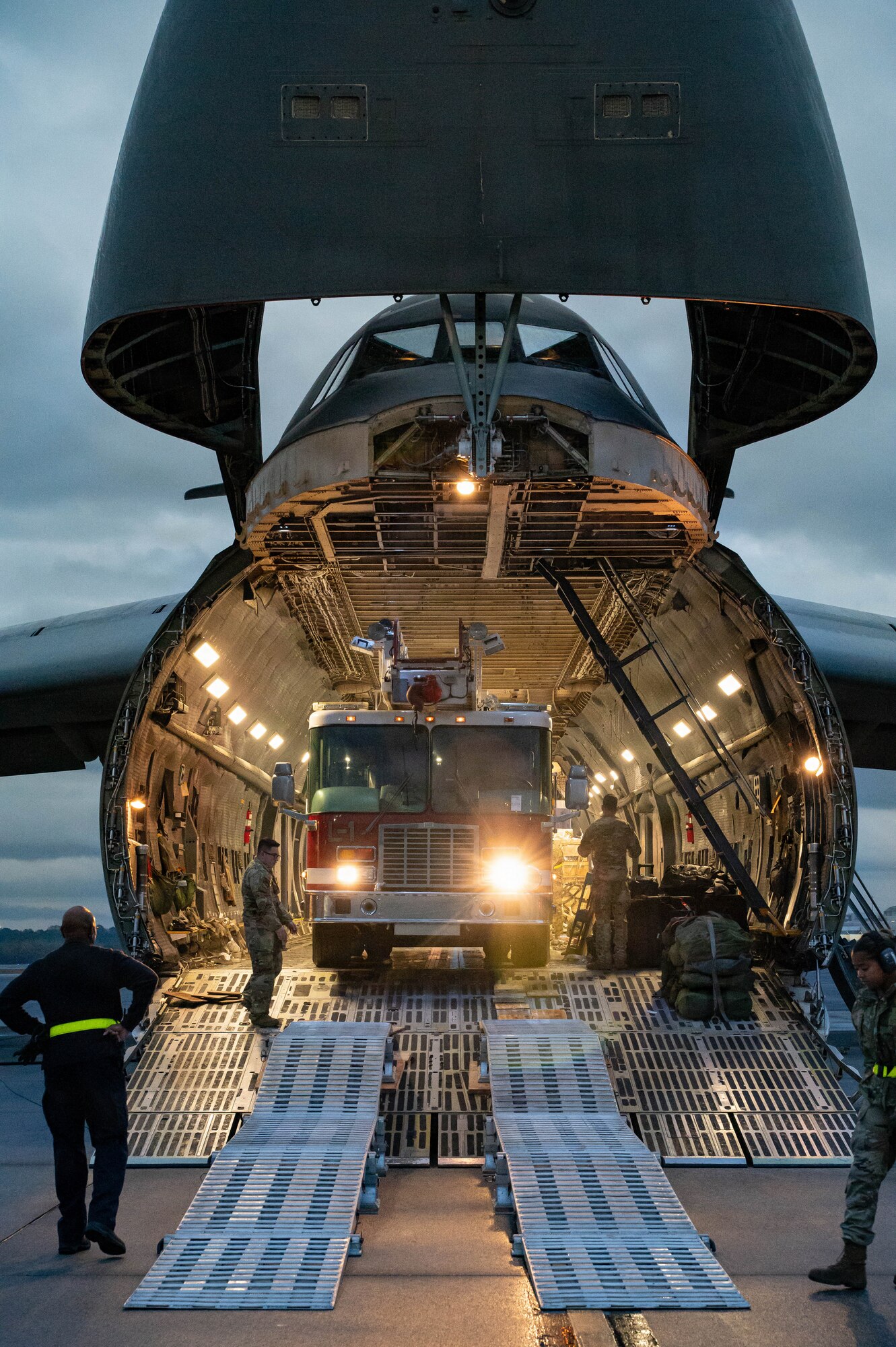 A firetruck backs into a C-5 Galaxy aircraft