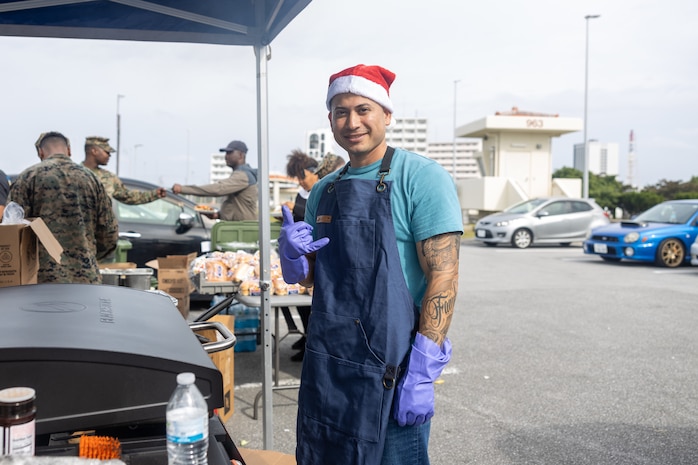 U.S. Marine Corps Staff Sgt. Jonathan Jacobo, a motor transport operations chief with Combat Logistics Regiment 37, 3rd Marine Logistics Group, poses for a photo during the CLR-37 holiday party at Camp Kinser, Okinawa, Japan, Dec. 19, 2025. CLR-37 held the event to strengthen camaraderie and foster esprit de corps among Marines and their families through shared food and festivities. Jacobo is a native of California. (U.S. Marine Corps photo by Cpl. Jonathan Rodriguez Pastrana)