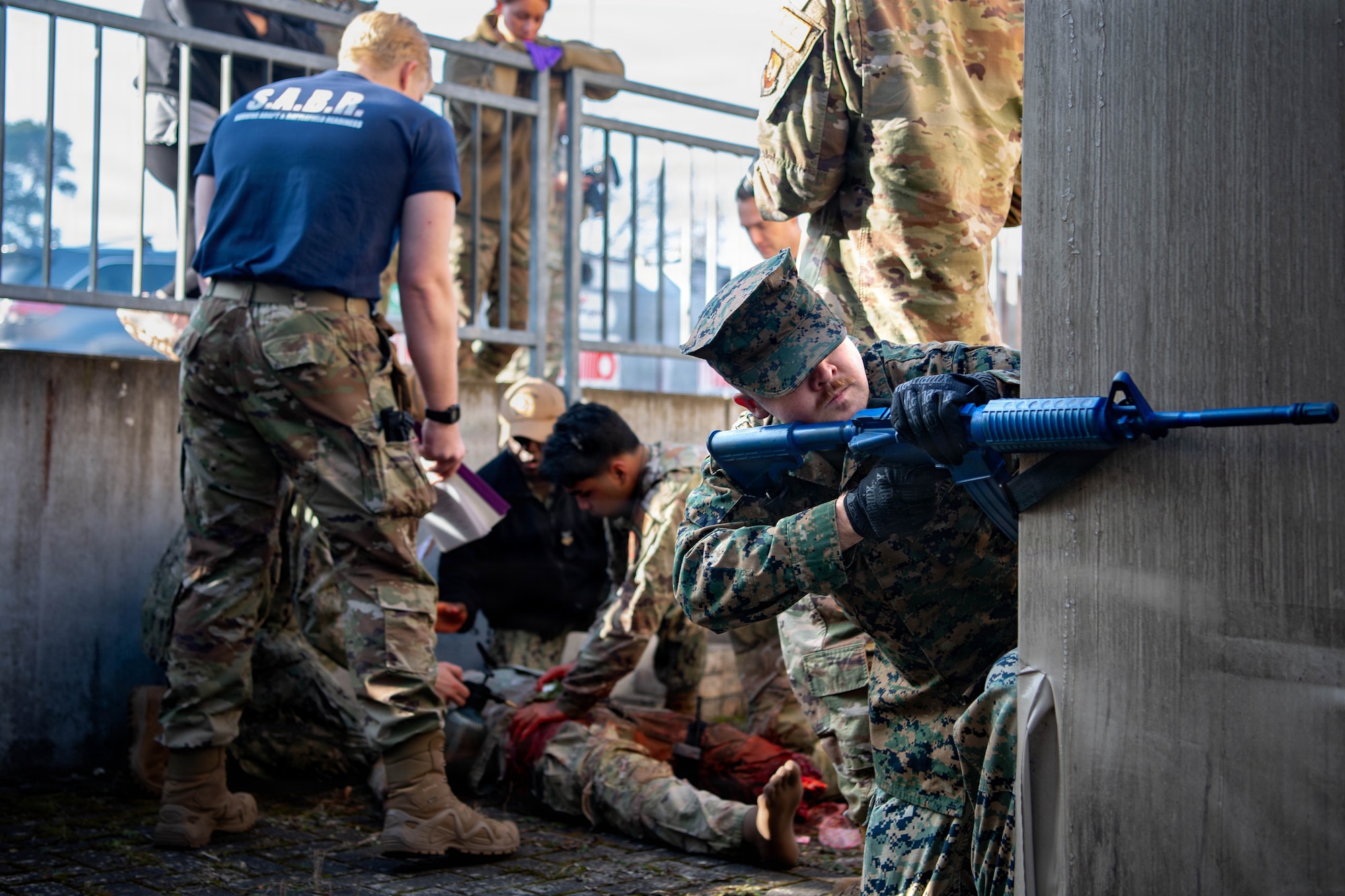 U.S. Air Force Airmen, Army, Marines and Navy medical personnel work together to guard and perform triage for a simulated patient at Survive, Adapt and Battlefield Readiness exercise at Landstuhl Regional Medical Center, Germany, Jan. 22,. 2026.