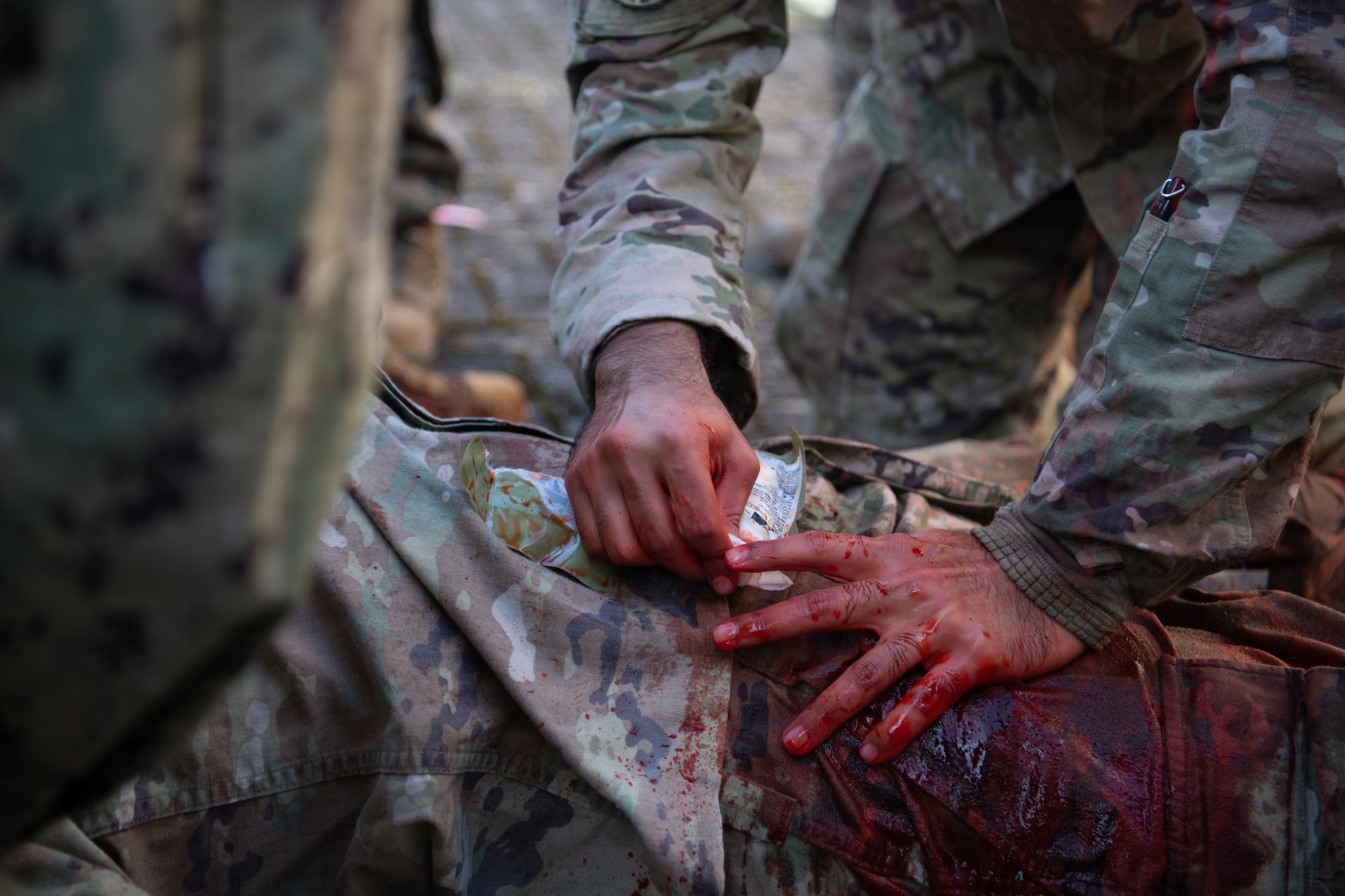 A U.S. Air Force medic dresses a simulated wound during Survive, Adapt and Battlefield Readiness exercise at Landstuhl Regional Medical Center, Germany, Jan 22, 2026.