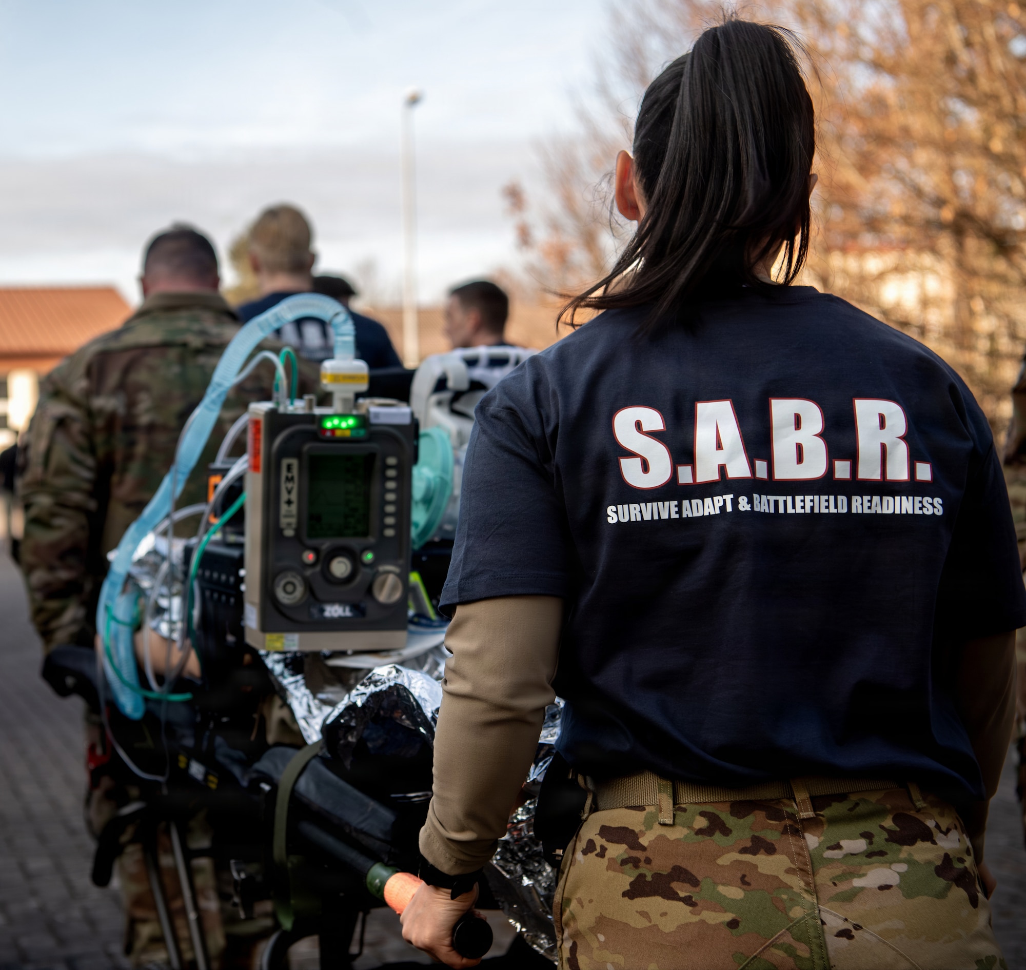 Cadre assist U.S. Air Force Airmen, assigned to the 86th Medical Group, carry a gurney during Survive, Adapt and Battlefield Readiness exercise at Landstuhl Regional Medical Center, Germany, Jan. 22, 2026.