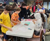 K-12 students assemble candy cane ornaments at the Camden County Public Library in Kingsland, Ga., on Dec. 17, 2025. Strategic Weapons Facility, Atlantic (SWFLANT) hosted a STEM Story Time event at the library where students learned about basic coding principles and how they apply to real-life naval operations. 

SWFLANT is one of two sites responsible for the Navy’s strategic assets. Its mission is to deliver safe, secure and effective sea-based strategic deterrence to Ohio-class ballistic missile submarines. The command also supports the reconfigured guided missile submarines, which carry Tomahawk cruise missiles.