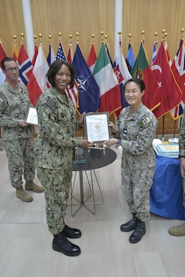CAPTAIN Raynese Roberts, Commanding Officer, U.S. Naval Hospital Naples, presents the Primary Care Medical Home Certificates to CDR Mia Jin; Medical
Home Port Naval Hospital, Naples.