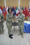 Captain Raynese Roberts presents the Leapfrog Top General Hospital Award to LT Michael Ahner on behalf of U.S. Naval Hospital Naples.