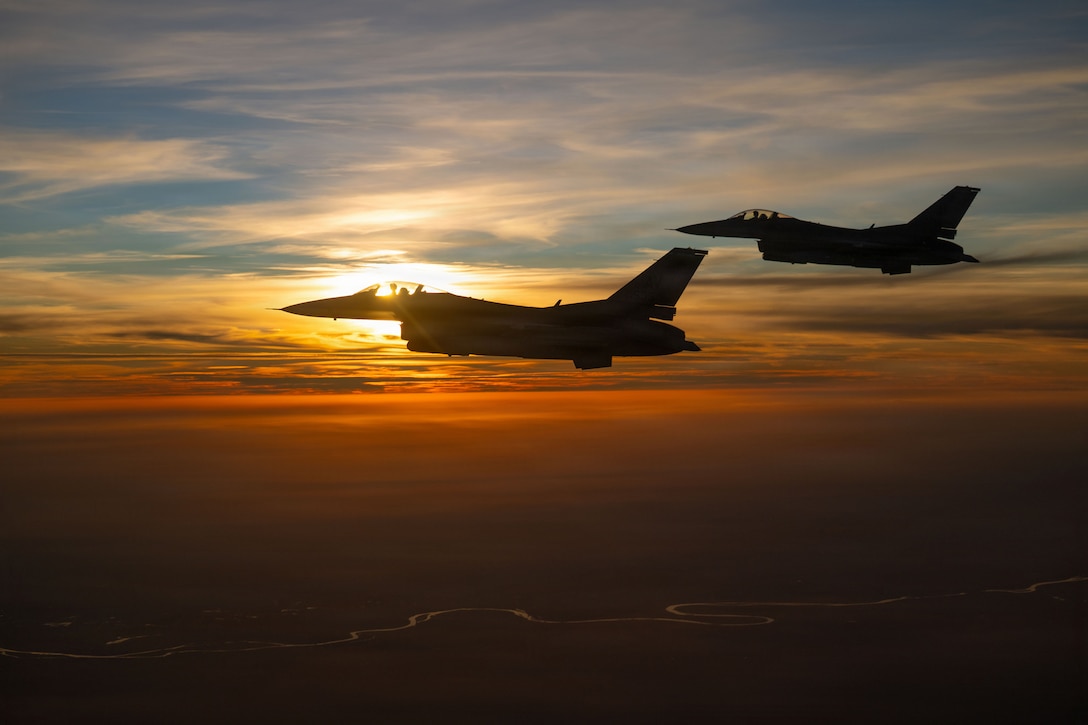 Two U.S. Air Force F-16 Fighting Falcon aircraft fly alongside a KC-135 Stratotanker aircraft over the U.S. Central Command area of responsibility, Dec. 30, 2025. The F-16 played a key role in executing airpower missions, deterring aggression, and participating in broader security across the CENTCOM AOR. (U.S. Air Force photo by Tech. Sgt. Nicholas Monteleone)