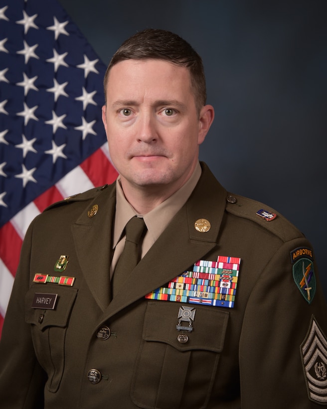 CSM Jonathan P. Harvey poses for his official command photo in front of the United States flag.