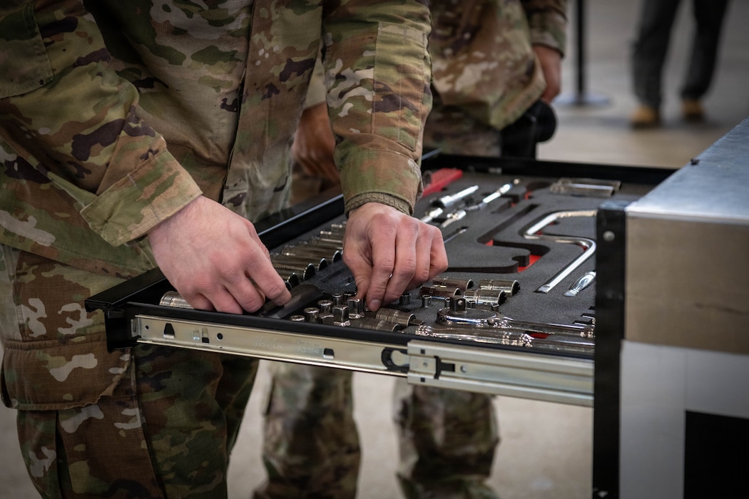 A U.S. Air Force Airman places tools in a toolbox.