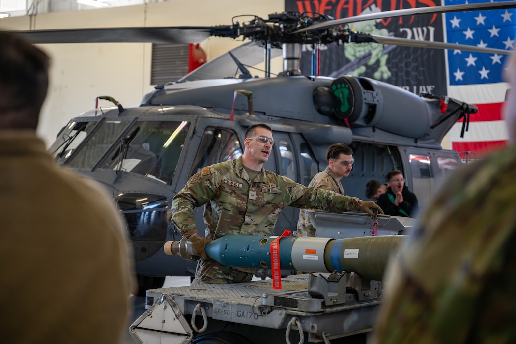 Man points to another, giving instruction.