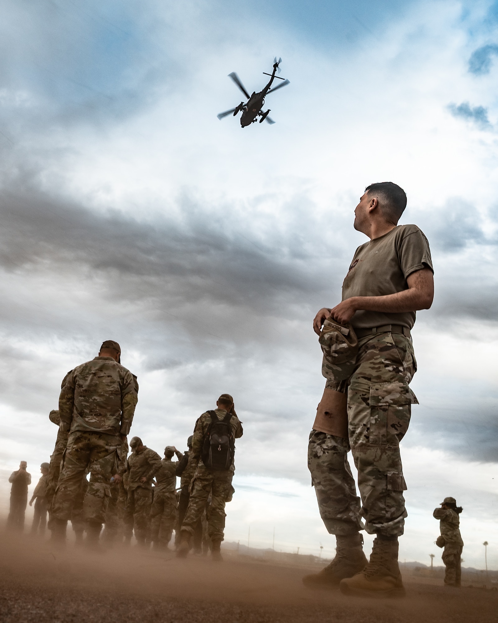 U.S. Air Force Airmen assigned to the 56th Fighter Wing observe a hoist operation during a simulated deployment for 56th FW honorary commanders