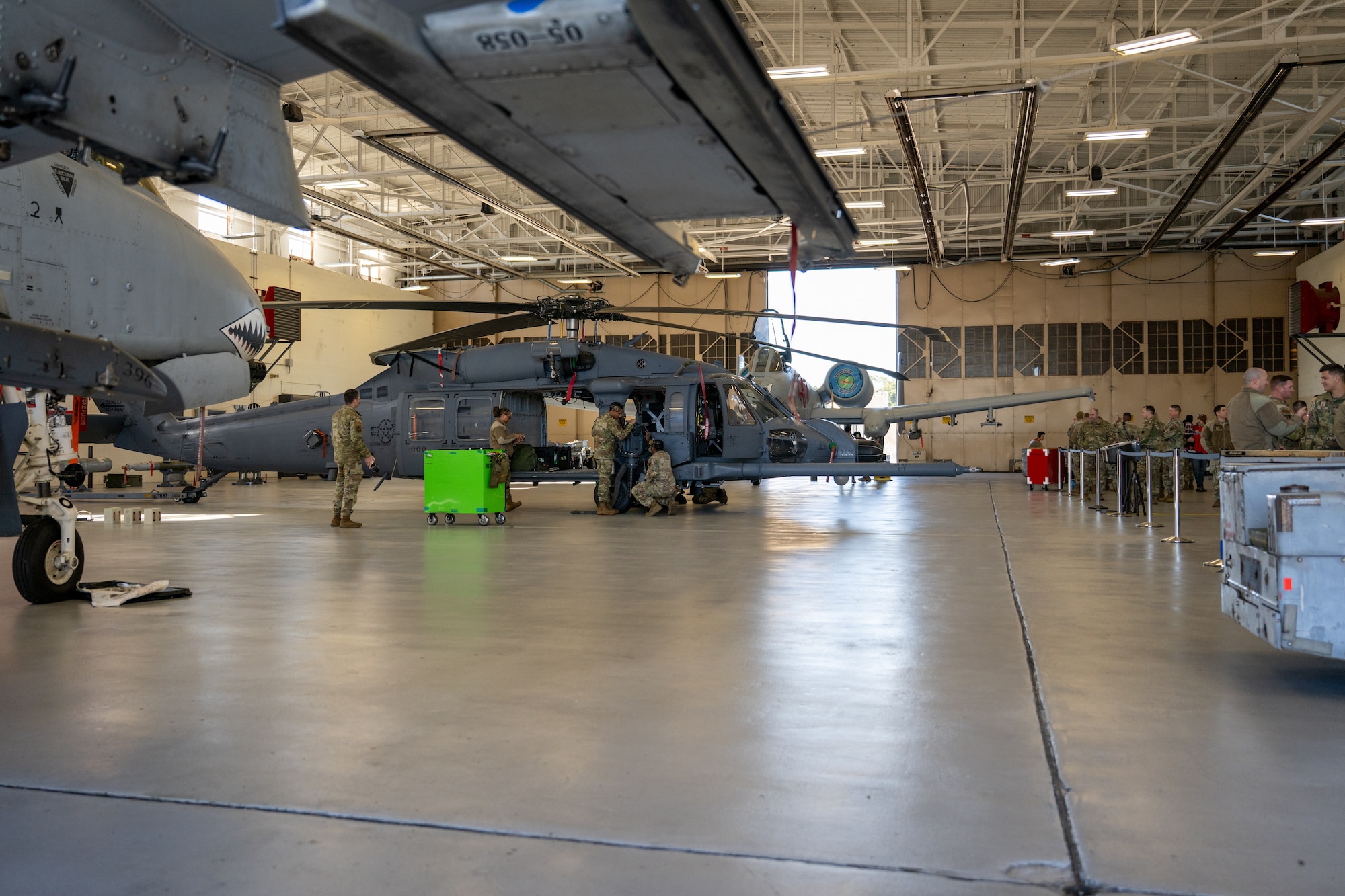 A wide view of the hangar as people work.