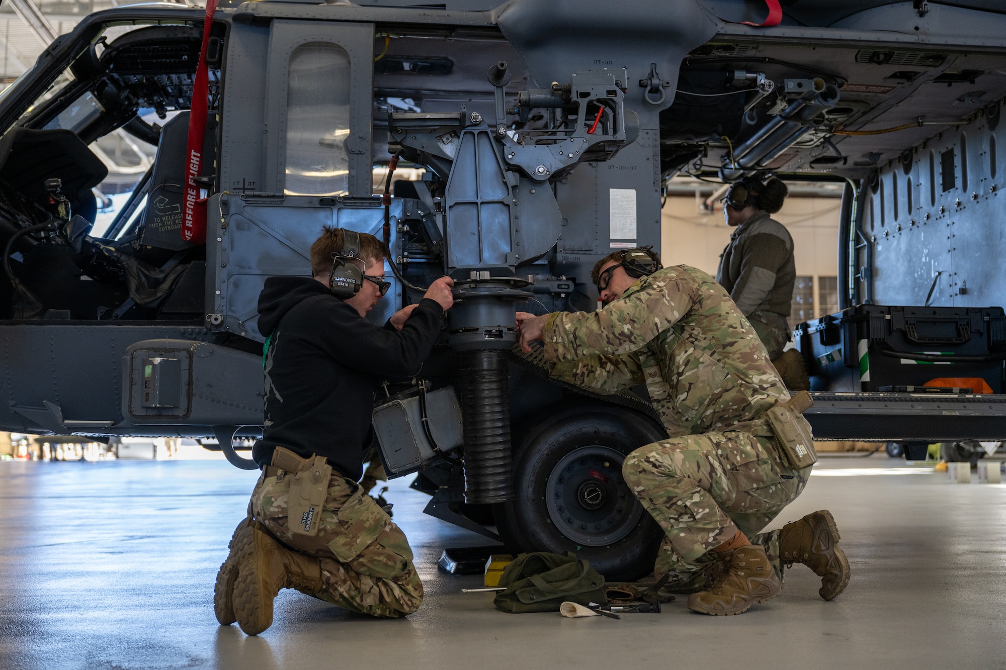 Men work on machinery.