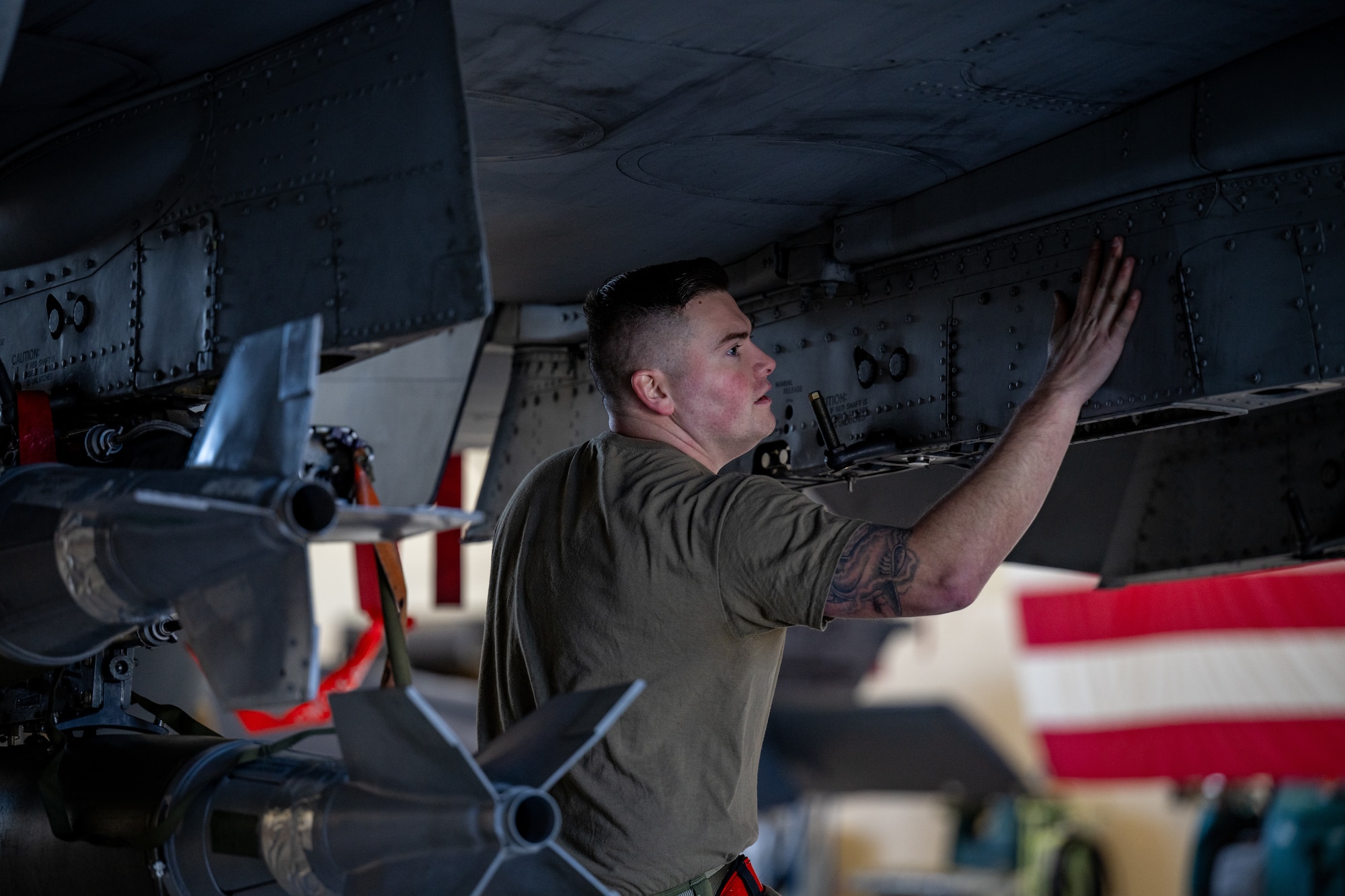 Man inspects machine.