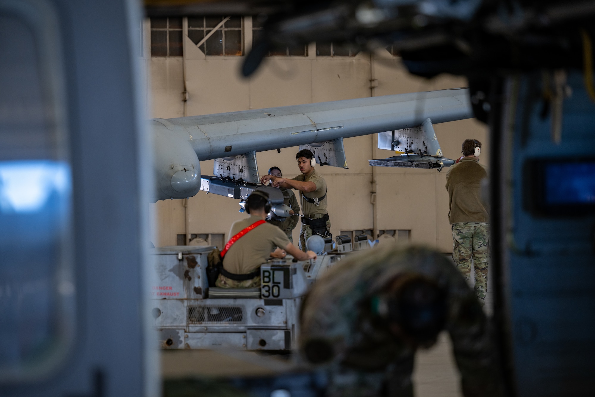 Men work on machinery.