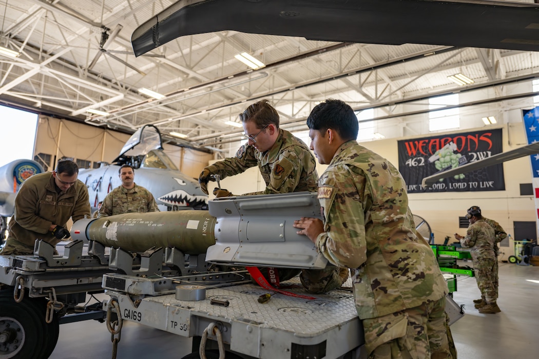 Men work on machine.