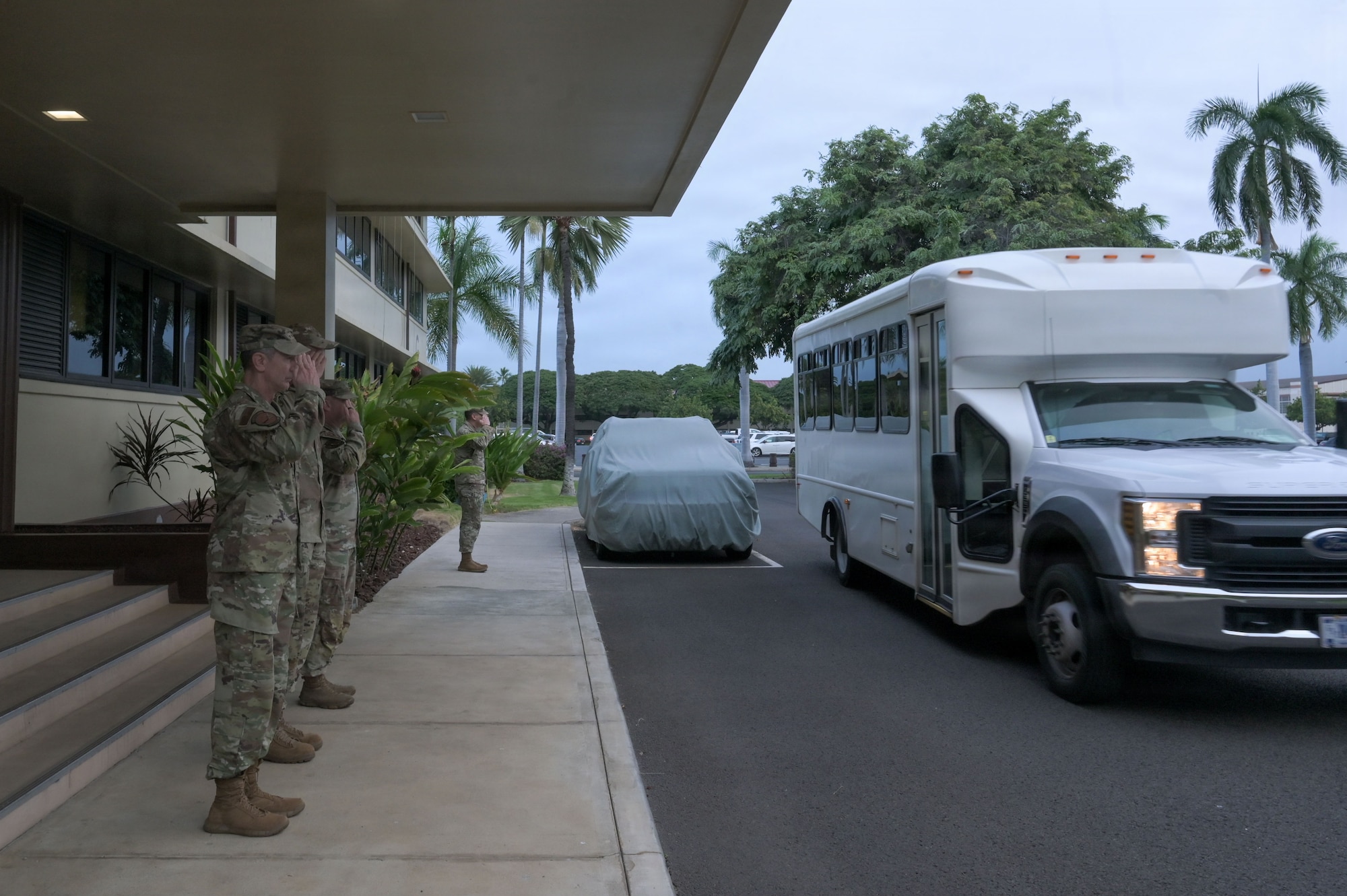 U.S. Air Force Gen. Kevin Schneider, Pacific Air Forces commander, and other members of PACAF leadership salute as Under Secretary of the Air Force Matt Lohmeier arrives at Joint Base Pearl Harbor-Hickam, Hawaii