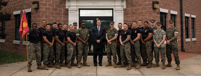U.S. Marine Corps Ret. Gen. James L. Jones, 32nd Commandant of the Marine Corps, center, and Marines with the Martial Arts and Fitness Center of Excellence pose for a photo during the Marine Corps Martial Arts 25th anniversary symposium hosted by the MAFCE at Raider Hall on Marine Corps Base Quantico, Virginia, Oct. 8, 2025. The goal of this symposium was to provide the Fleet Marine Force with instructions and practical application on the new tan-black belt syllabus and the new free sparring events while integrating guided discussions fostering character development and recounting the storied tradition of the Marine Corps Martial Arts Program. (U.S. Marine Corps photo by Cpl. Joshua Barker)