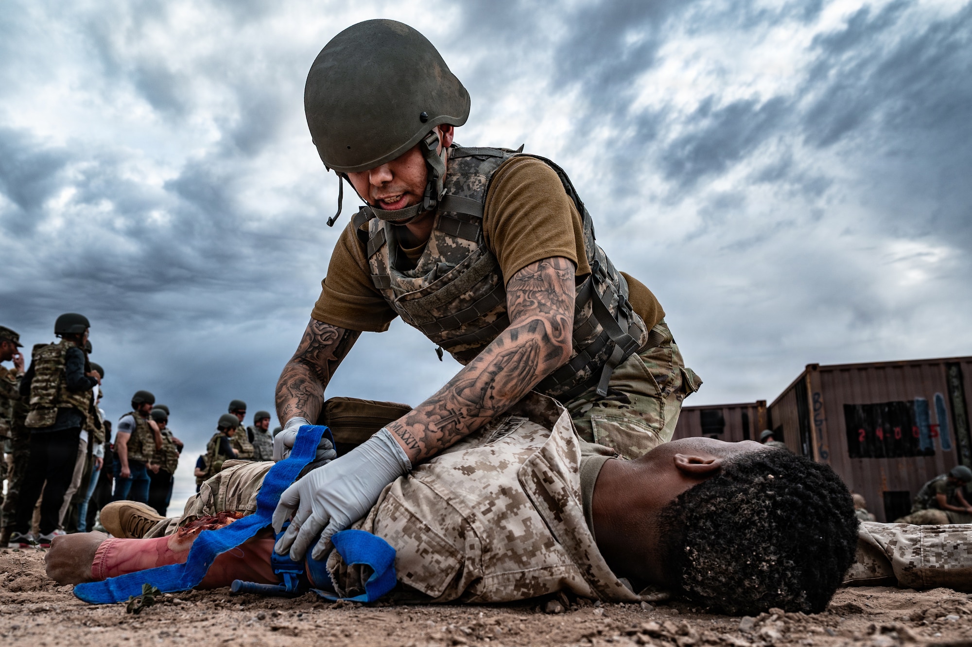 U.S. Air Force Airmen assigned to the 56th Fighter Wing perform a medical evacuation demonstration for 56th FW honorary commanders during a simulated deployment, Jan. 22, 2026, at Gila Bend Air Force Auxiliary Field, Arizona. The demonstration illustrated the requirements for providing critical care to casualties within a deployed environment. This exposure provided civic partners with the technical context of the medical skills necessary to sustain combat readiness. (U.S. Air Force photo by Airman 1st Class Belinda Guachun-Chichay)
