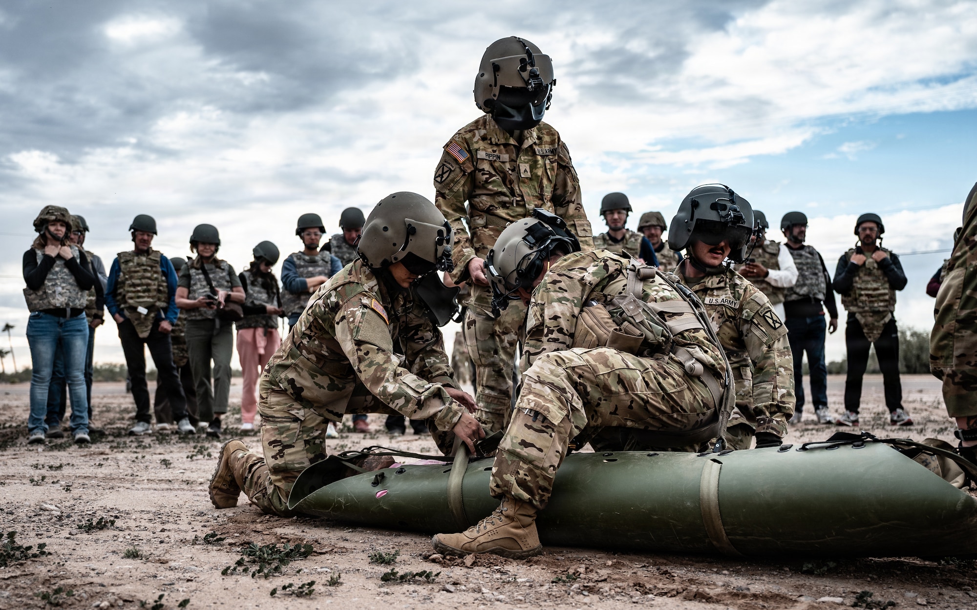 U.S. Army National Guard soldiers demonstrate casualty care, hoist operations and helicopter-loading procedures to 56th Fighter Wing honorary commanders, Jan. 22, 2026, at Gila Bend Air Force Auxiliary Field, Arizona. These exercises showcased the joint interoperability required to provide life-saving care in high-pressure environments. Understanding these frontline medical requirements allows civic partners to better communicate the complexity of the 56th FW mission to the local community. (U.S. Air Force photo by Airman 1st Class Belinda Guachun-Chichay)