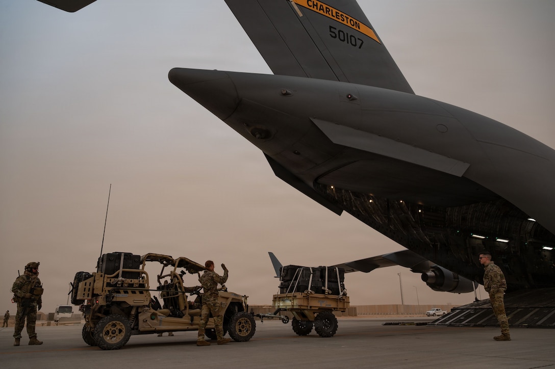 U.S. Air Force ­­­­­­­­­­Senior Airman Emma Duffany, 16th Expeditionary Airlift Squadron loadmaster, directs cargo onto a C-17 Globemaster III aircraft during a mission in the U.S. Central Command area of responsibility, Dec. 29, 2025. Loadmasters assigned to the 16th EAS are responsible for supervising the loading, securing and unloading of cargo, vehicles and people while providing passenger comfort and safety. (U.S. Air Force photo by Tech. Sgt. Bailee A. Darbasie)
