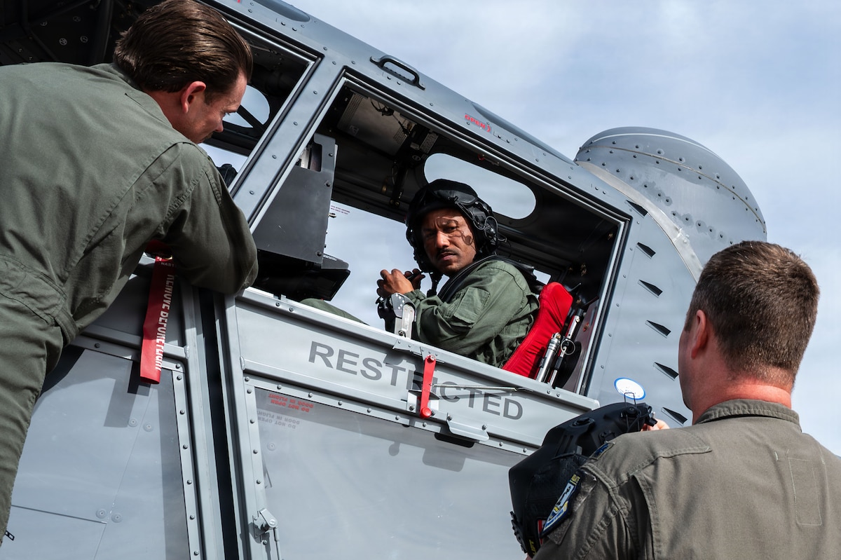 U.S. Air Force Chief Master Sgt. Kelvin Hatcher, 355th Wing command chief, adjusts the microphone on his helmet with guidance from aircrew assigned to the 492nd Special Operations Wing at Davis-Monthan Air Force Base, Arizona, Jan. 21, 2026. The 492nd SOW trains aircrews flying the Skyraider II to be ready to go whenever they are called upon to support Air Force Special Operations Command missions, any time, any place. (U.S. Air Force photo by Senior Airman Jasmyne Bridgers-Matos)