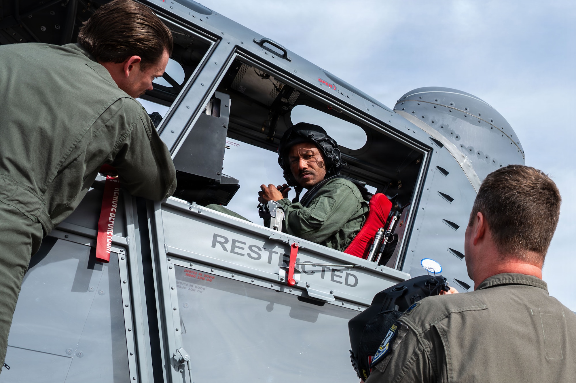 U.S. Air Force Chief Master Sgt. Kelvin Hatcher, 355th Wing command chief, adjusts the microphone on his helmet with guidance from aircrew assigned to the 492nd Special Operations Wing at Davis-Monthan Air Force Base, Arizona, Jan. 21, 2026. The 492nd SOW trains aircrews flying the Skyraider II to be ready to go whenever they are called upon to support Air Force Special Operations Command missions, any time, any place. (U.S. Air Force photo by Senior Airman Jasmyne Bridgers-Matos)
