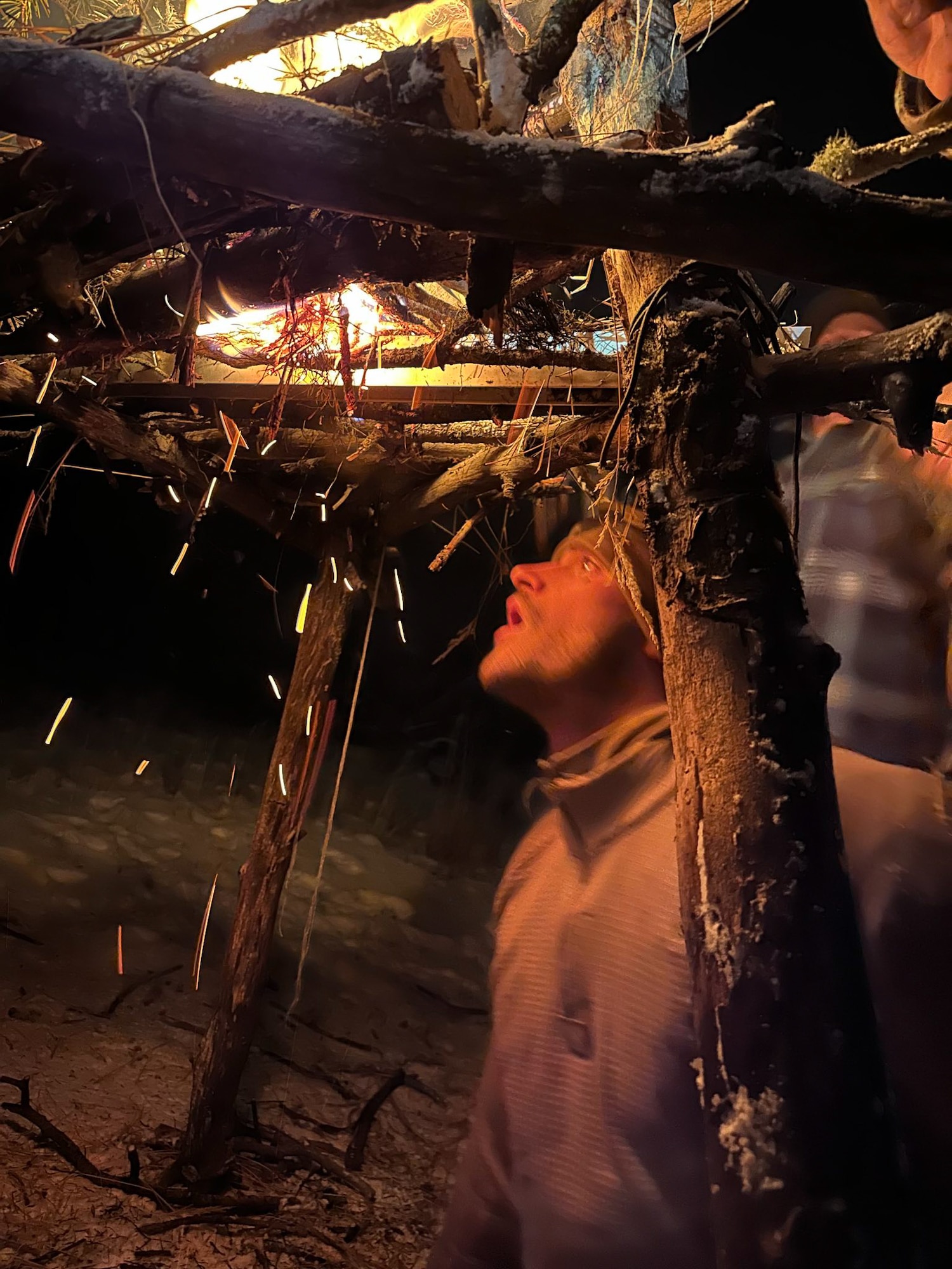 Garrigues is below a platform that hold the signal fire, he is feeding it to keep lit.