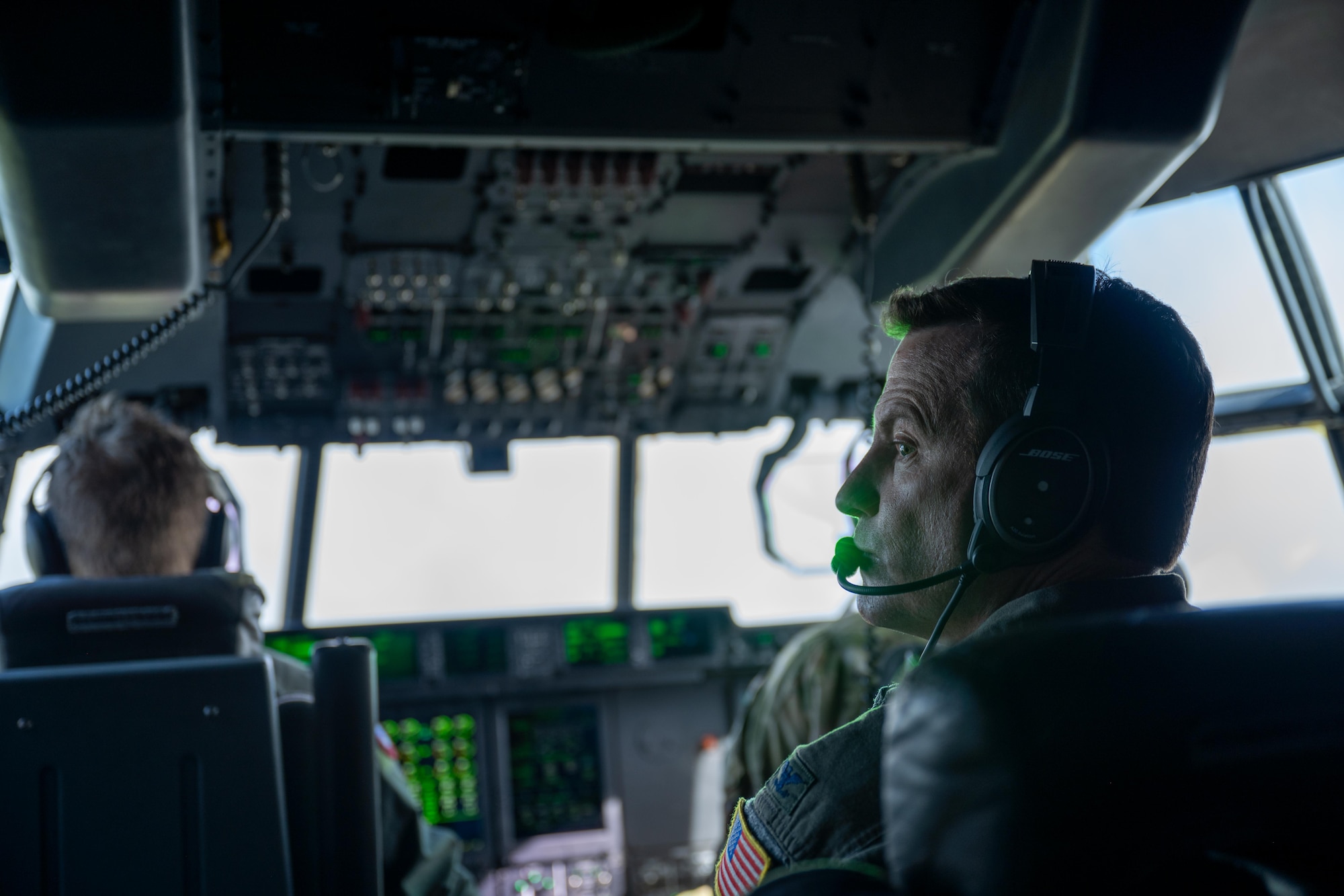 U.S. Air Force Col. Justin Diehl, 317th Airlift Wing commander, observes flight operations on a C-130J Super Hercules assigned to the 317th AW during a Maximum Endurance Operation en-route to Won Pat International Airport, Guam, for Exercise Palmetto Reach, Jan. 14, 2025. During the exercise, C-130J and C-17 Globe Master III aircrews executed formation flights and joint mission planning, demonstrating how tactical and strategic airlift capabilities complement one another in contested and resource-limited environments to deliver global mobility effects. (U.S. Air Force photo by Airman 1st Class Adrien Tran)