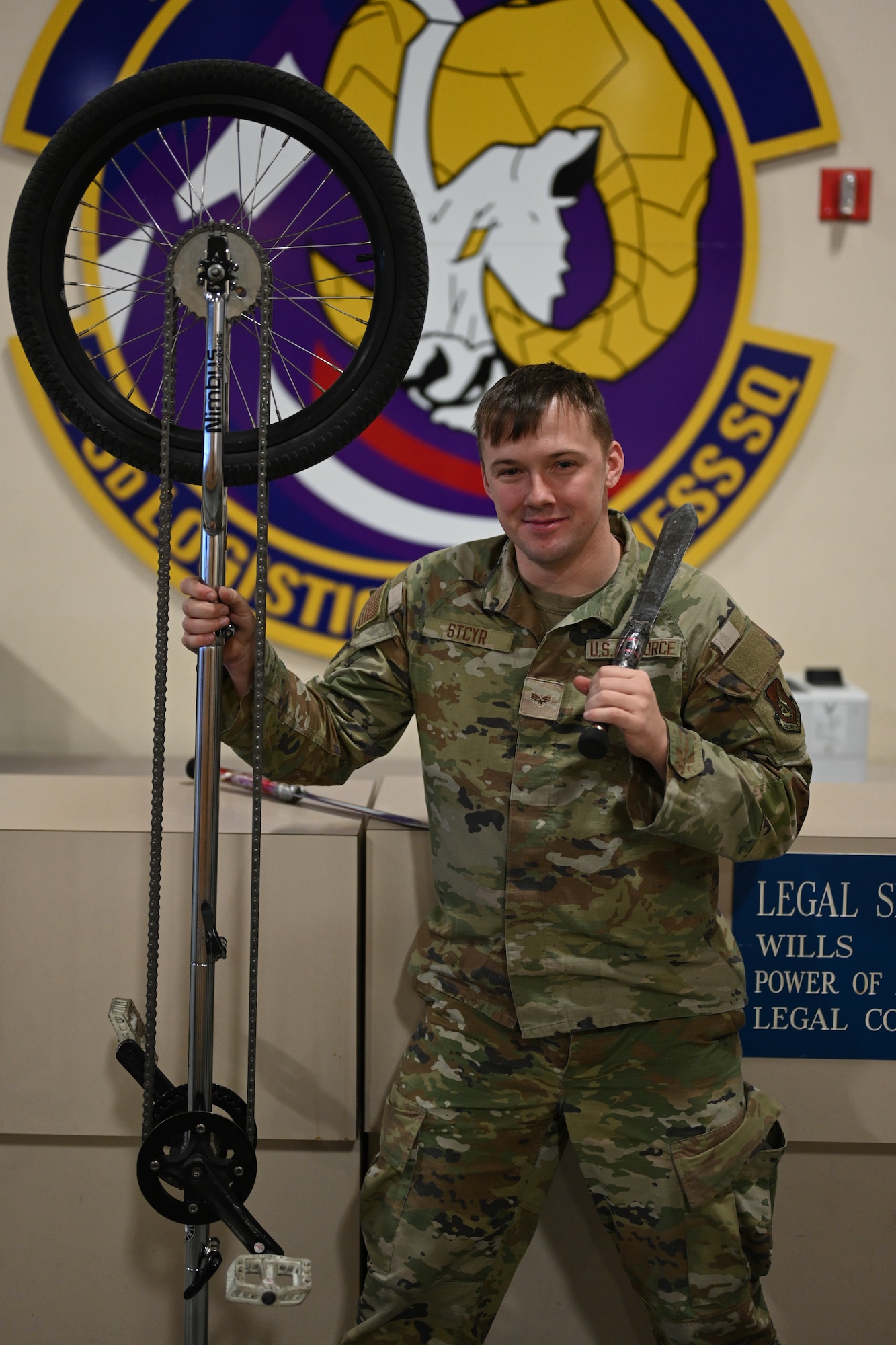 Senior Airman Rick Stcyr stands with some of his performance equipment on Joint Base Elmendorf-Richardson, Alaska, Dec. 2, 2025. Stcyr serves as a logistics planner with the 773d Logistics Readiness Squadron and practices as well as performs circus style stunts in his free time, pursuing resilience through performance. (U.S. Air Force photo by Airman 1st Class Eli A. Rose)
