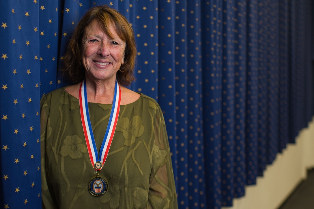 A person poses for a photo at ceremony.