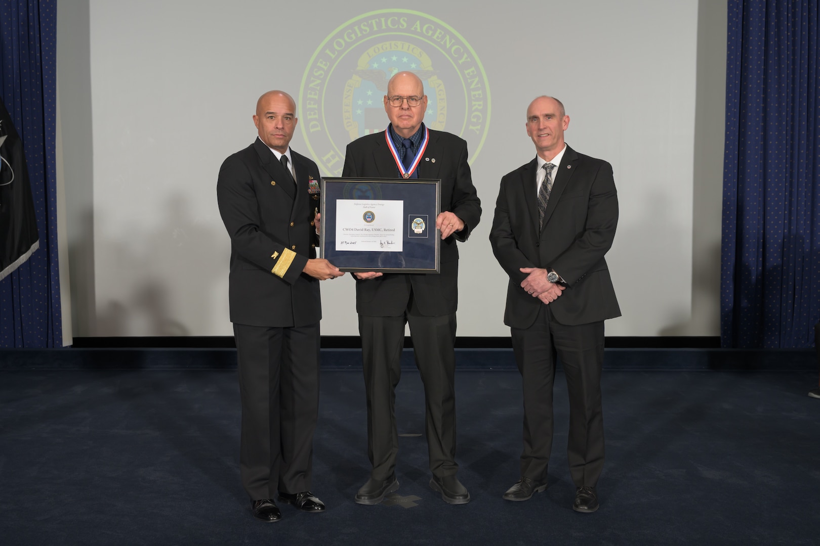 People pose for picture at ceremony.