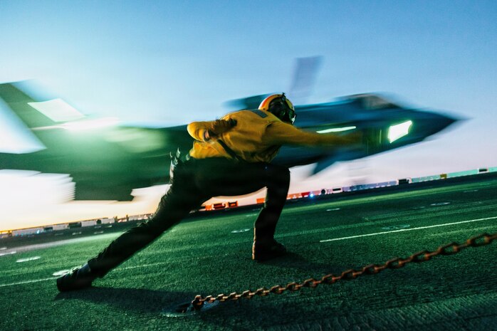 A U.S. Sailor assigned to Wasp-class amphibious assault ship USS Boxer (LHD 4) launches a U.S. Marine Corps F-35B Lightning II with Marine Fighter Attack Squadron (VMFA) 122, 11th Marine Expeditionary Unit, from the flight deck Boxer in the Pacific Ocean, Jan. 26, 2026.