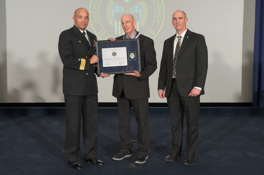 People pose for a photo at ceremony.