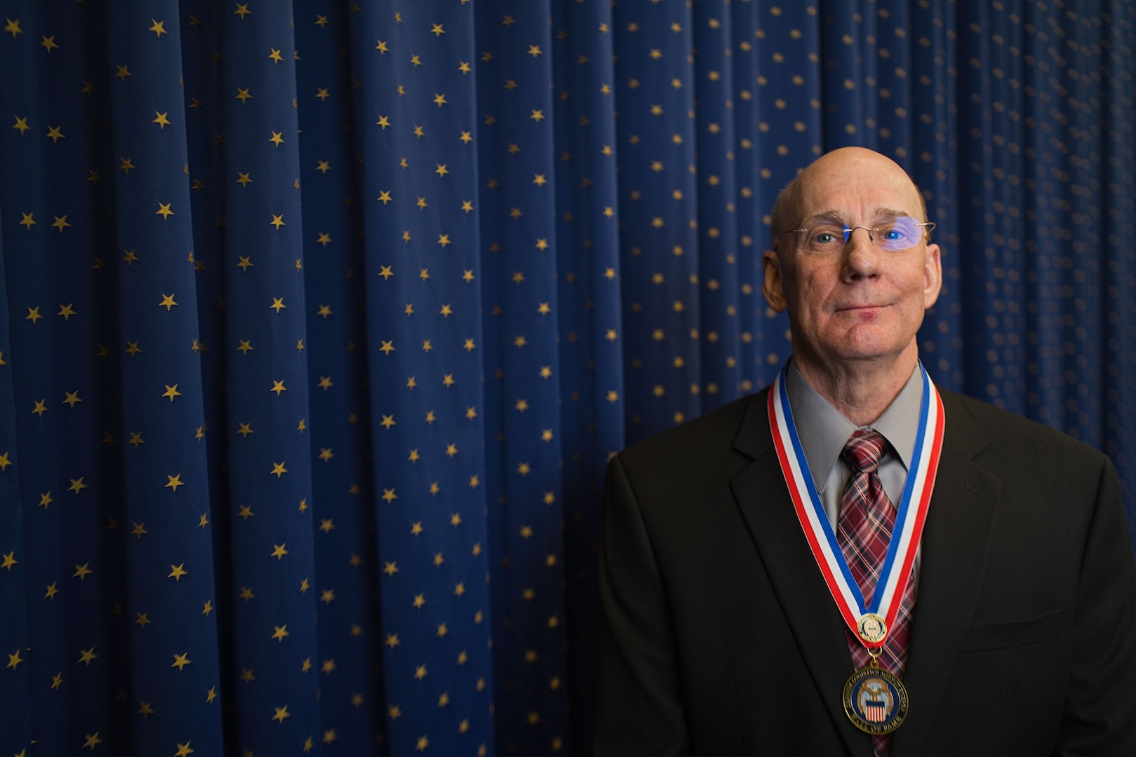 A person pose for a photo at ceremony.