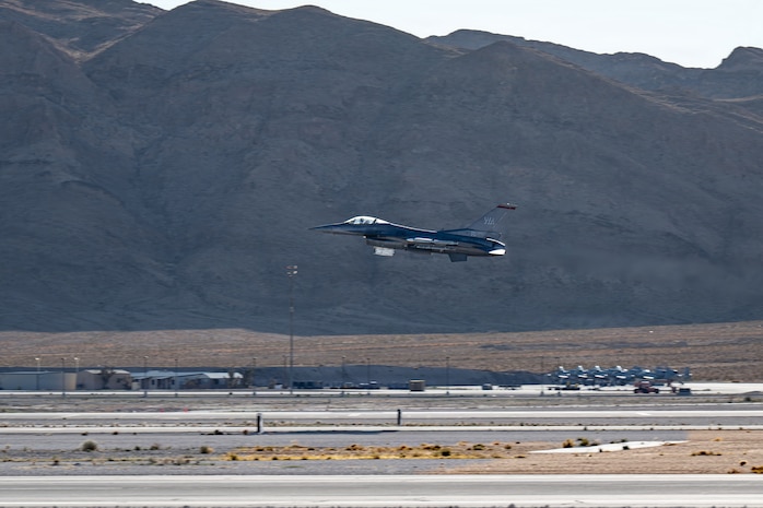 An F-16 Fighting Falcon takes off from the runway at Nellis Air Force Base.