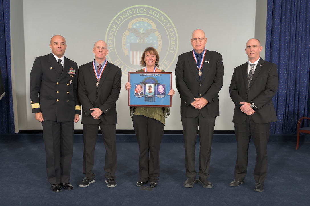 People pose for a photo at ceremony.