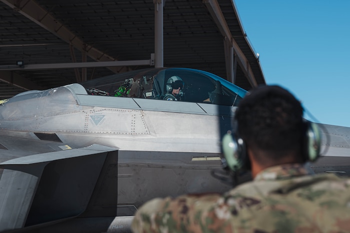 Senior Airman Christopher Hinds performs preflight procedures while Air Force Chief of Staff Gen. Ken Wilsbach taxis on the platform.