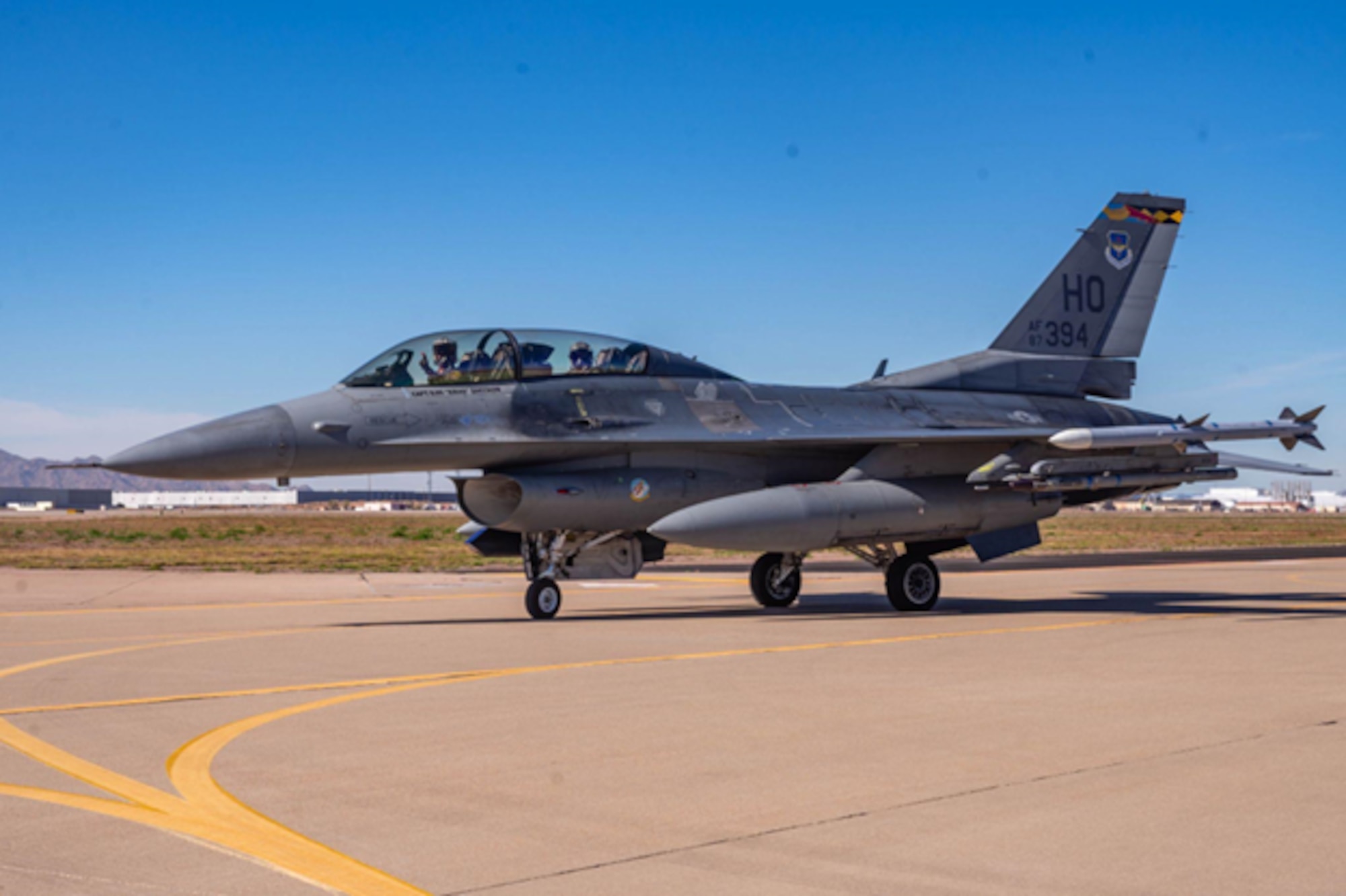 U.S. Air Force F-16 Fighting Falcon pilot waves at the camera before taking off for a joint exercise in a Holloman Air Force Base F-16, Jan. 27, 2026, at Luke Air Force Base, Arizona. F-16 and F-35 Lightning II pilots both emphasize the value of training together, noting that these missions enhance trust, communication and shared understanding of each aircraft’s role in combat. Mission planning and execution require constant collaboration, reinforcing procedures that will be essential during future forward deployments.