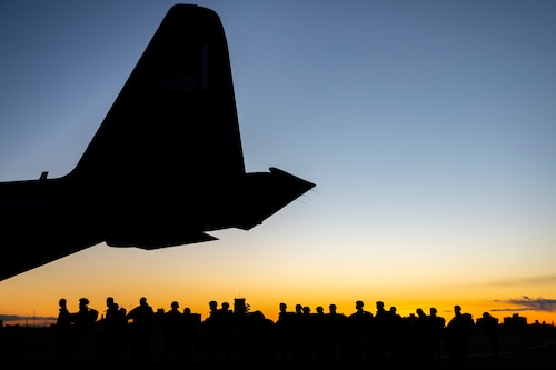 U.S. Army paratroopers assigned to the 11th Airborne Division, 2nd Brigade, prepare to board a U.S. Air Force C-130J Super Hercules assigned to the 36th Airlift Squadron.