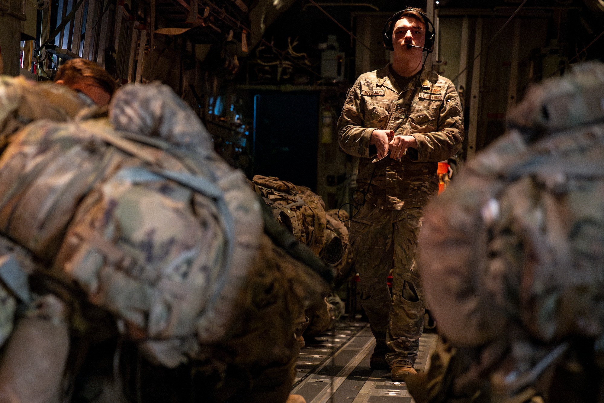 U.S. Air Force Senior Airman Cory McCloskey, 36th Airlift Squadron loadmaster, finalizes rigging for a static line jump during exercise North Wind 26.