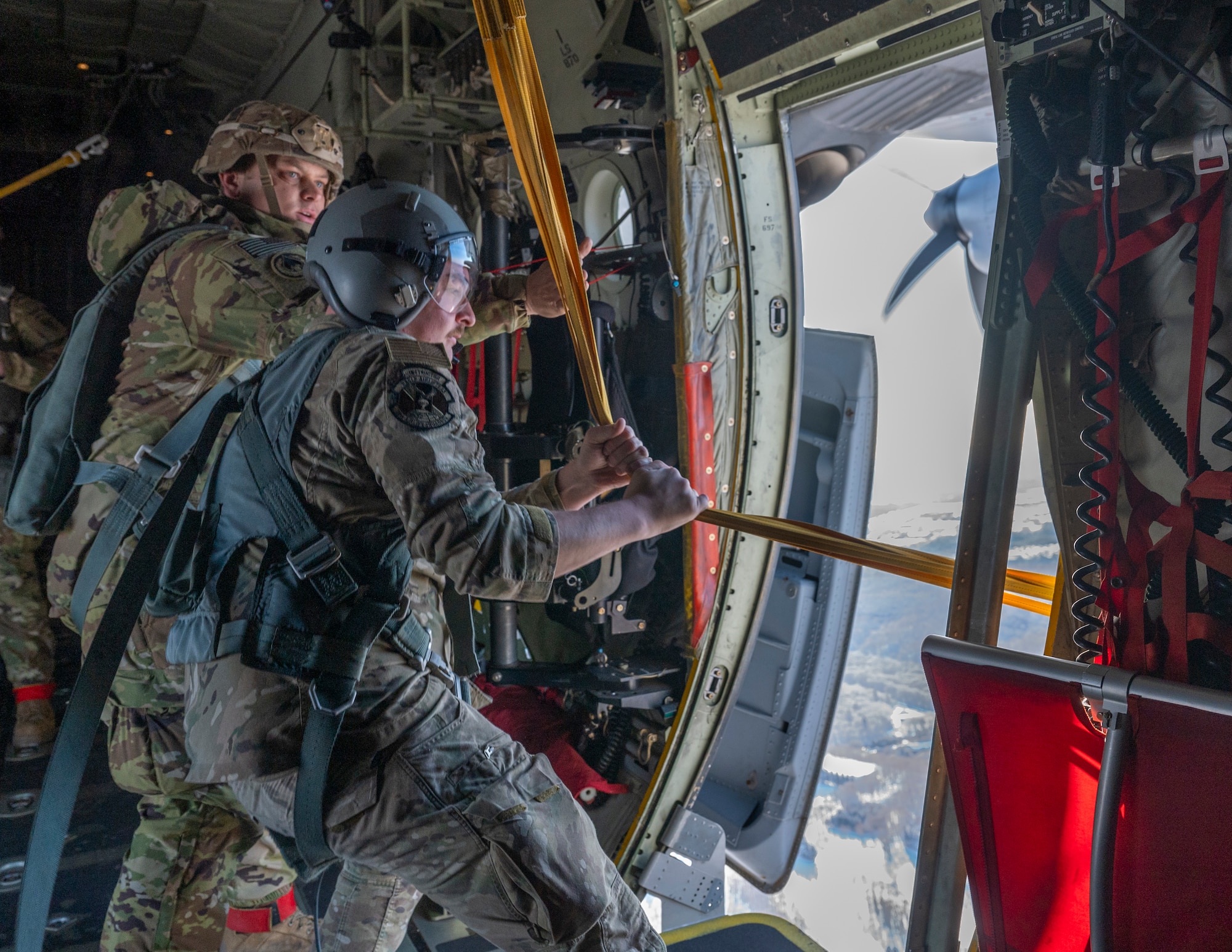 U.S. Air Force Senior Airman Cory McCloskey, right, 36th Airlift Squadron loadmaster, and a U.S. Army paratrooper assigned to the 11th Airborne Division, 2nd Brigade, recover static lines after personnel drops jump during exercise North Wind 26